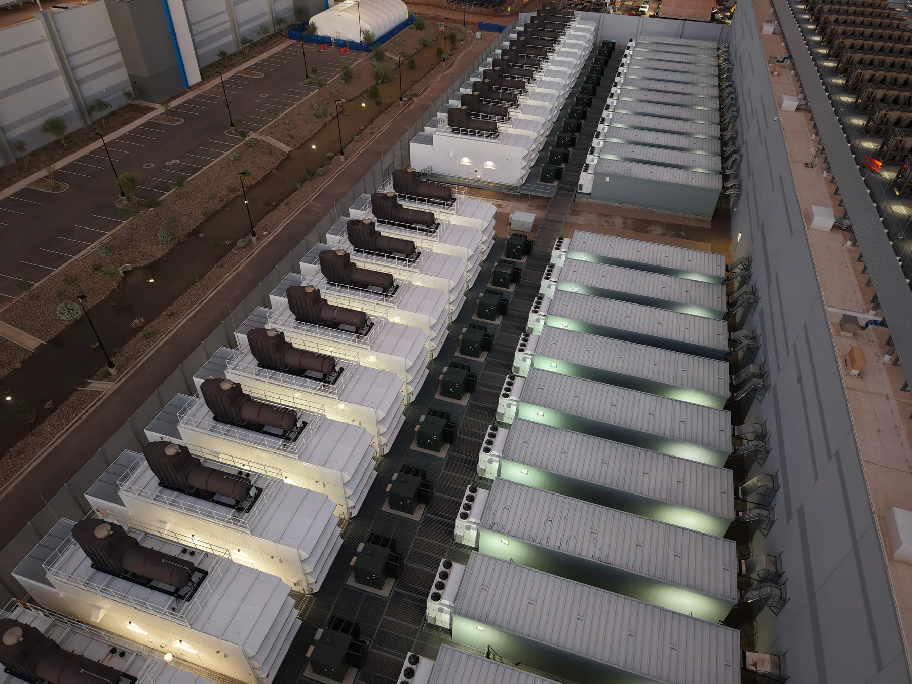 Rows of outdoor backup-generator enclosures at a data-centre facility